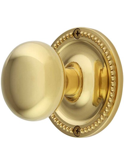 Large Beaded Rosette Door Set with Wrought Brass Knobs in Laquered Brass.